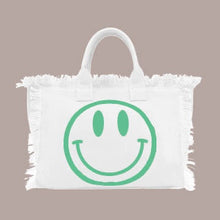 Load image into Gallery viewer, HAPPY HAPPY HAPPY TOTE MED BAG IS PERFECT FOR OCCASIONS. HAPPY FACE ON ONE SIDE AND GRAPHIC HAPPY HAPPY HAPPY ON THE OTHER SIDE. FRESH CREAM COLOR WILL GIVE LIFE TO ALL SUMMER OUTFITS AND SWIN SUITS
